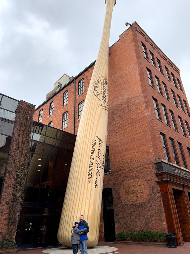 My husband and son standing outside of the Louisville Slugger Museum and Factory

