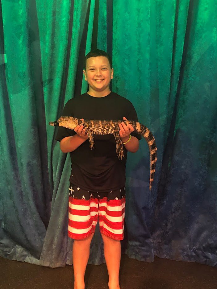 My son holding a Florida Alligator at the Gatorland Show