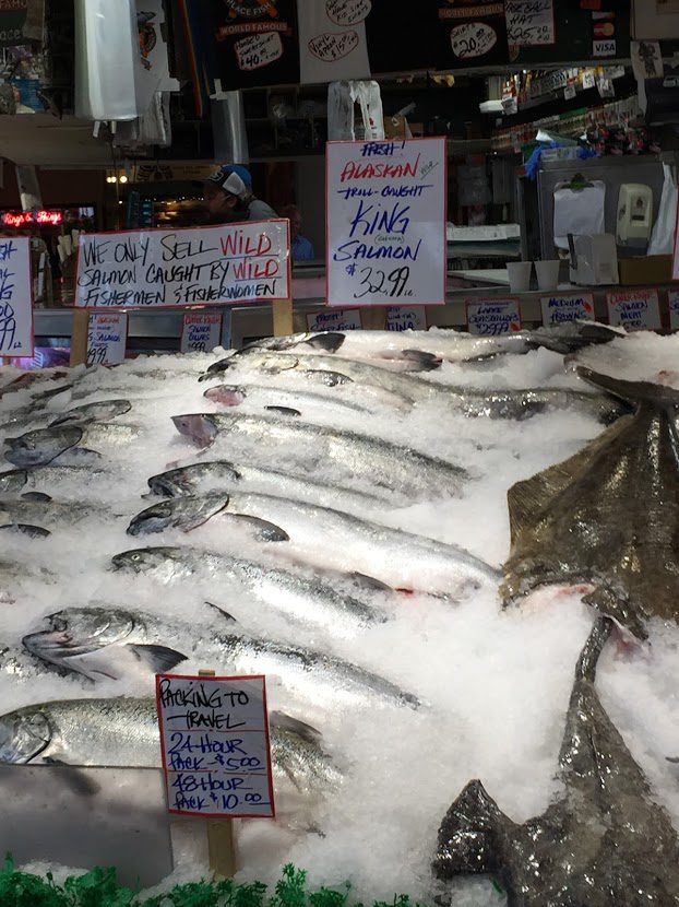 fishmongers throwing the daily catch at the Pike Place Fish Market