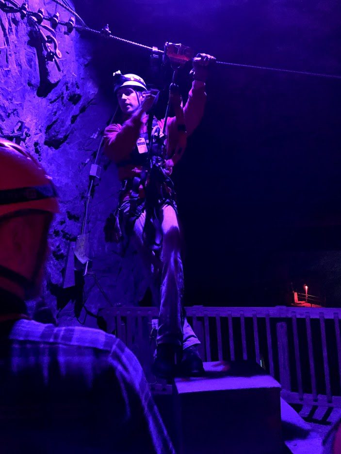 tour guide making sure all safety equipment is working