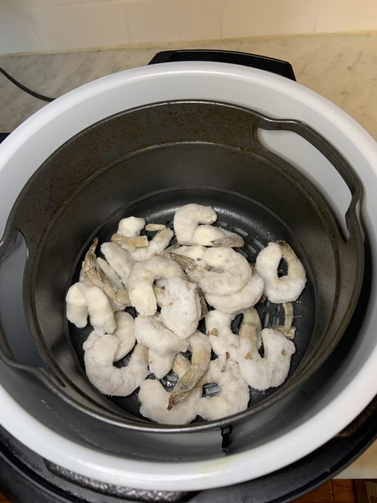 Place the frozen shrimp into the air fryer basket. Air fry for 10 minutes at 390 degrees until the shrimp turns from gray to pink