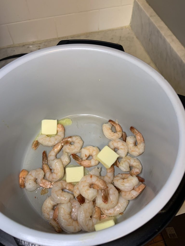 Transition to the shrimp to the removable pot of the Ninja Foodi, a pan on the stovetop, or add foil to your air fry basket to make the sauce.