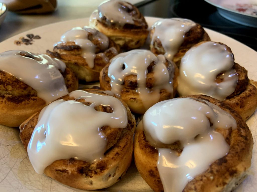Top the air fryer cinnamon rolls with icing