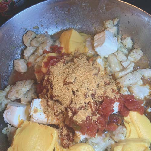 Add cheeses, Rotel, and taco seasoning to the cook chicken
